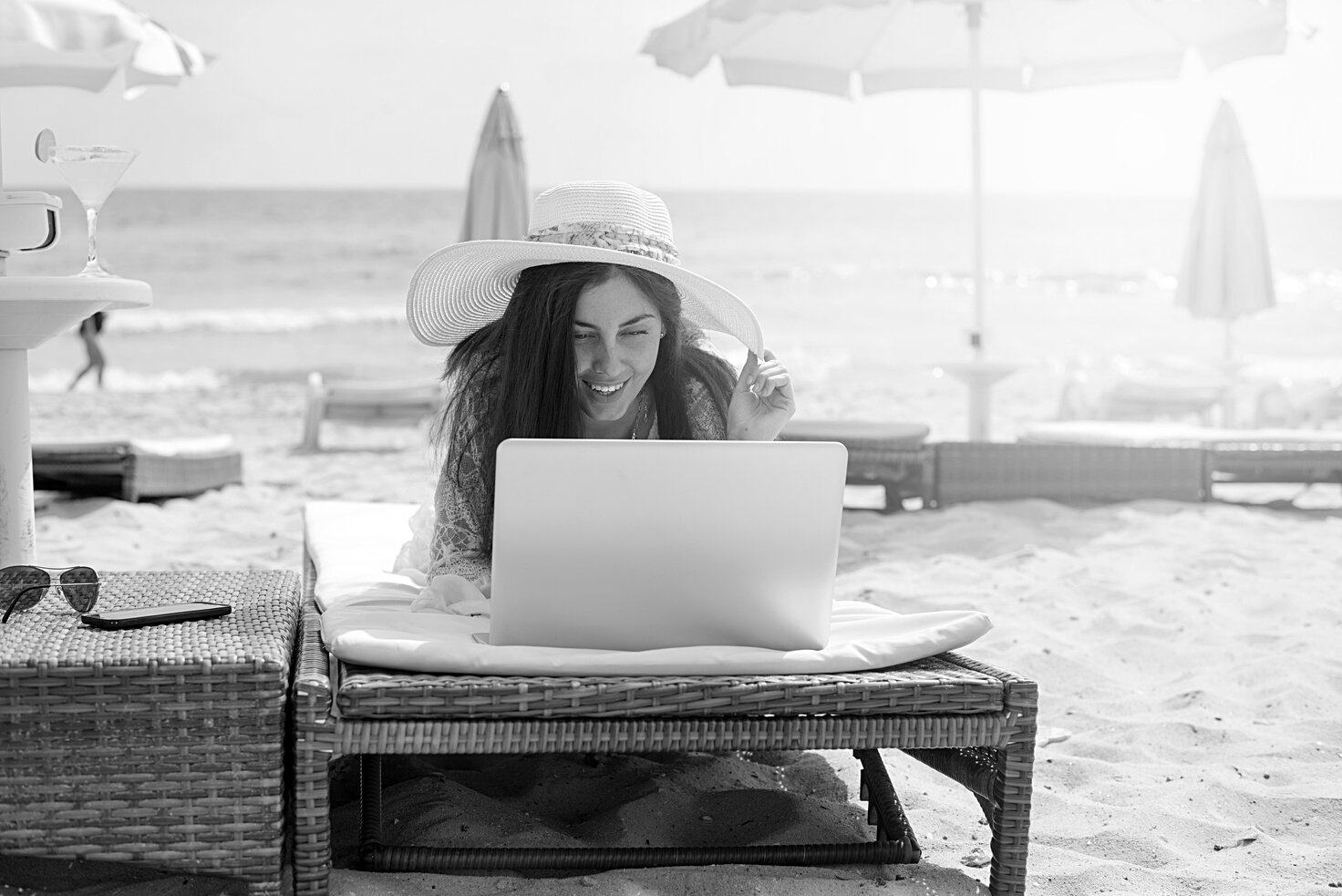 Women working in the beach with laptop